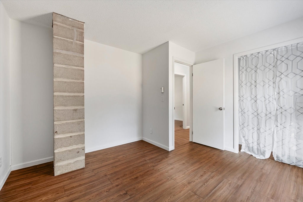 359 Bemis Road Warren, MA 01585 - Photo 22 of 27 a view of an empty room with wooden floor