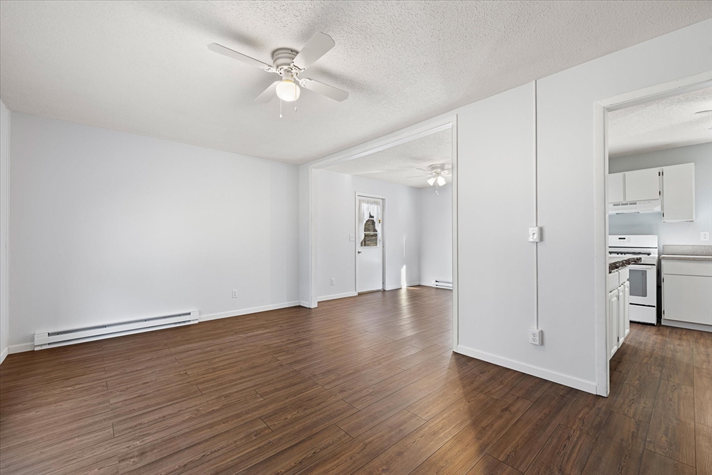 359 Bemis Road Warren, MA 01585 - Photo 8 of 27 an empty room with wooden floor and windows