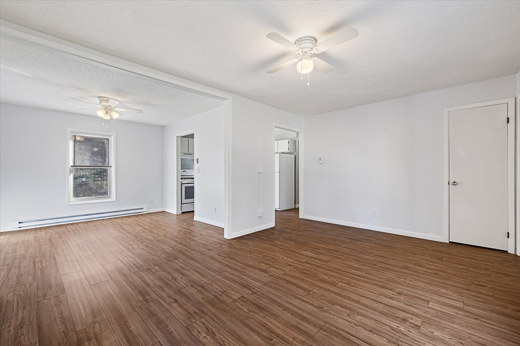 359 Bemis Road Warren, MA 01585 - Photo 9 of 27 a view of an empty room with wooden floor and a window