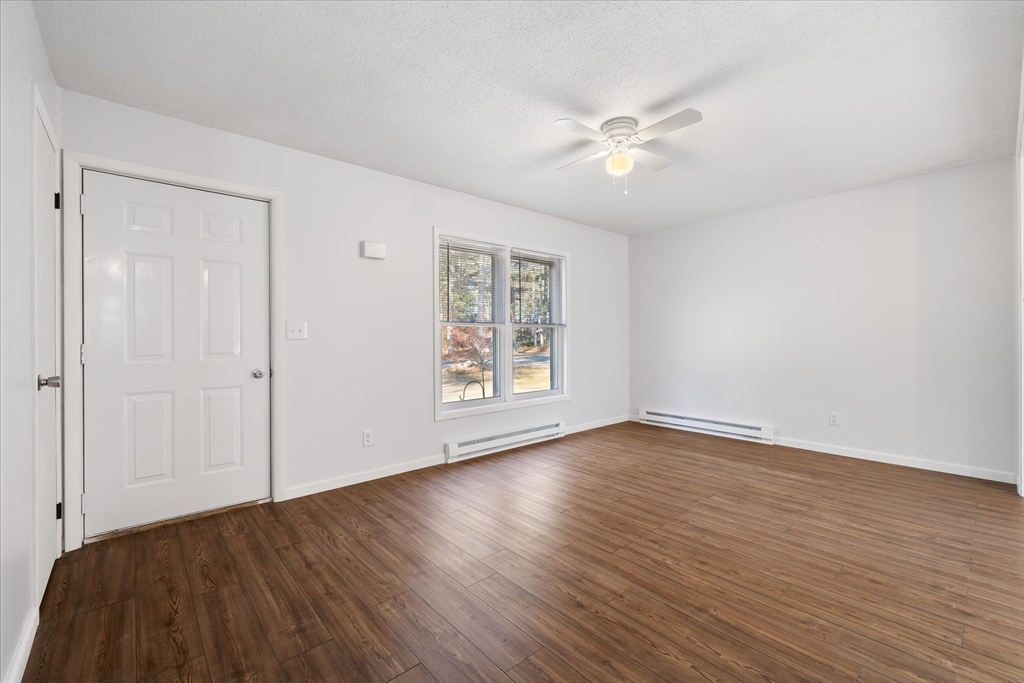 359 Bemis Road Warren, MA 01585 - Photo 10 of 27 a view of an empty room with wooden floor and a window