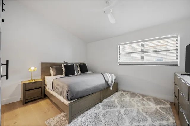 a bedroom with a bed and window