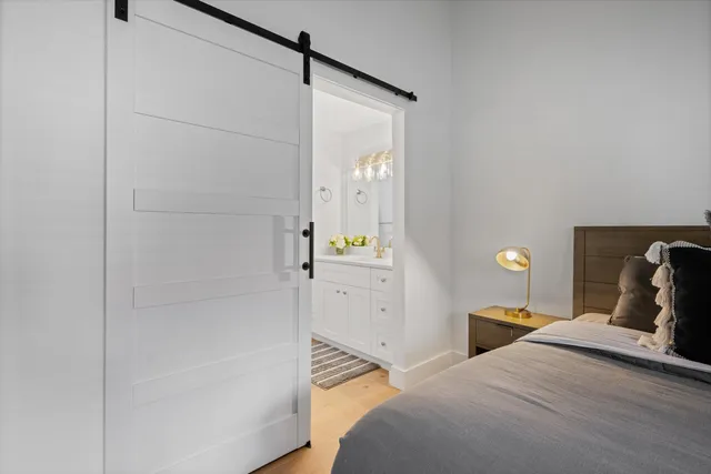 a bedroom with a bed and a mirror