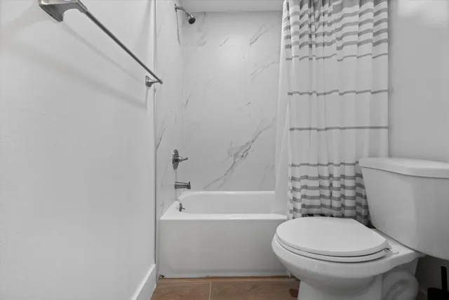 a bathroom with a toilet and a shower