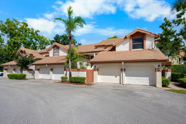 a view of a house with a yard and garage