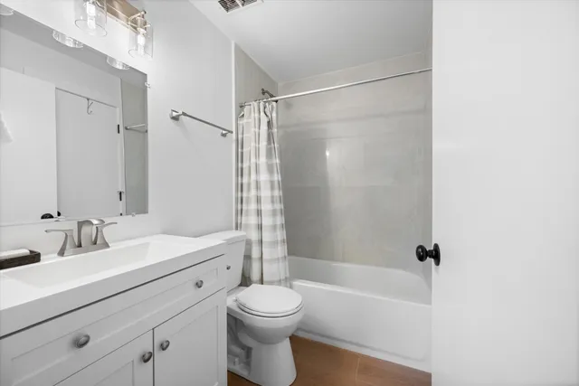 a bathroom with a sink mirror toilet and bathtub