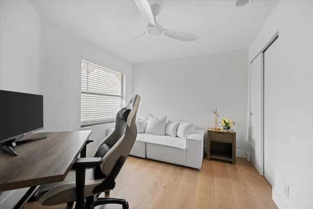 a living room with furniture a flat screen tv and a window