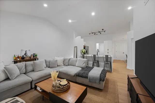 a living room with furniture and wooden floor