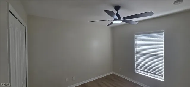 a spacious bathroom with a toilet a sink a mirror and vanity