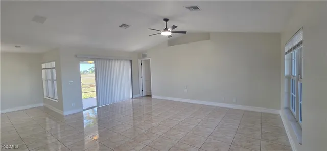 a view of an empty room with a ceiling fan