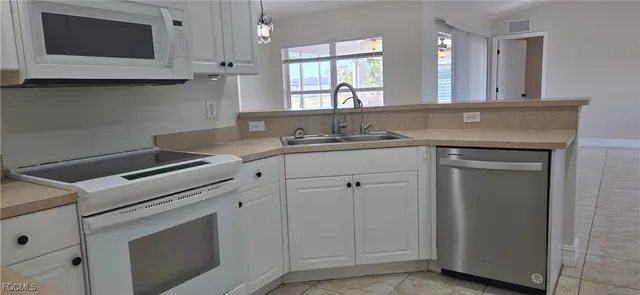 a kitchen with appliances cabinets and a sink