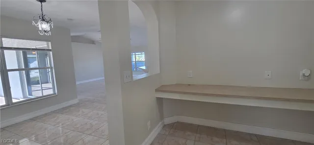 a room with a window and a chandelier