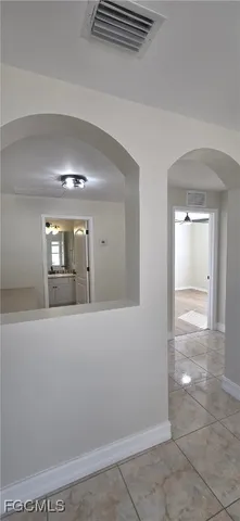 a view of a room with wooden floor and a ceiling fan