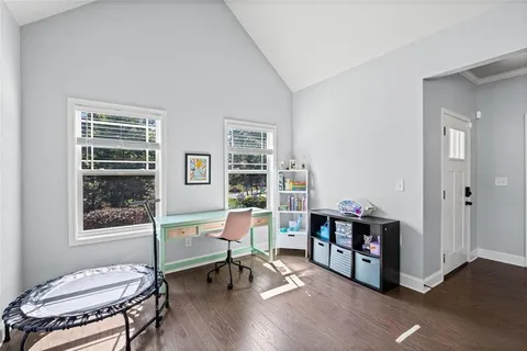 a workspace with furniture window and wooden floor