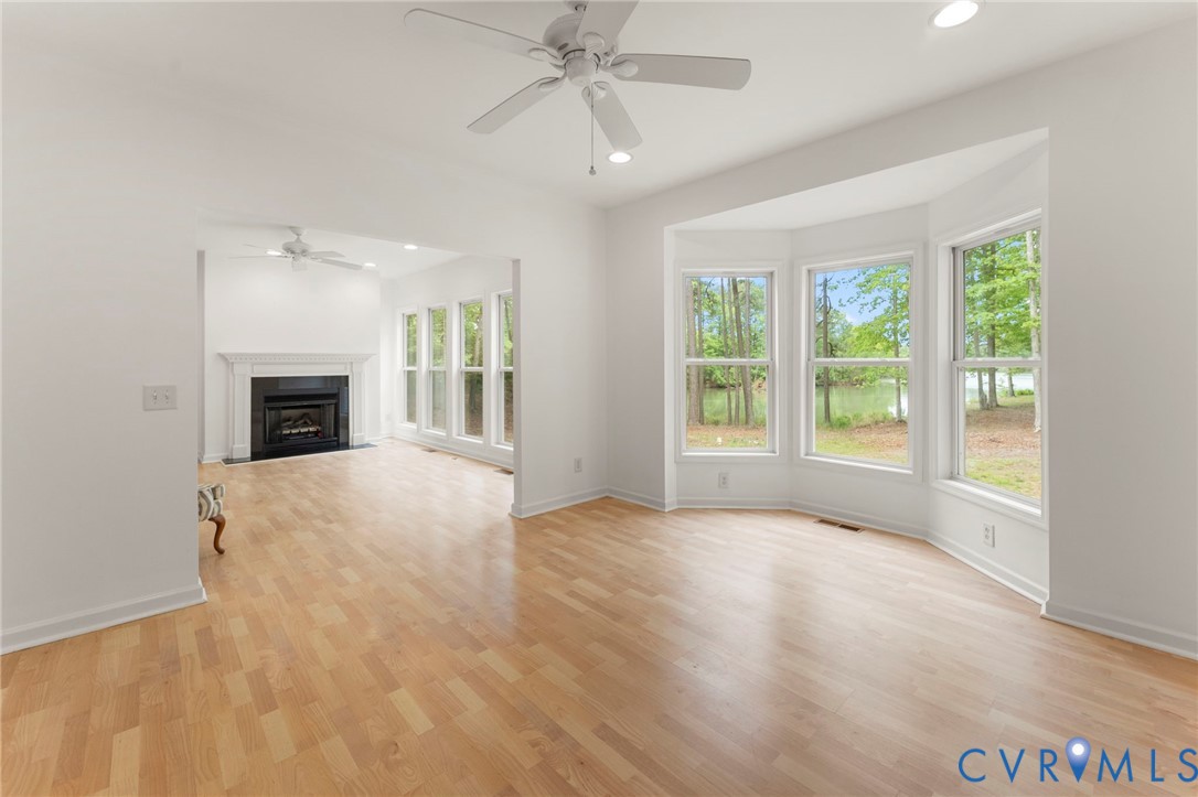 625 Whispering Pines Road Lancaster, VA 22503 - Photo 17 of 71 a view of an empty room with window and fire place