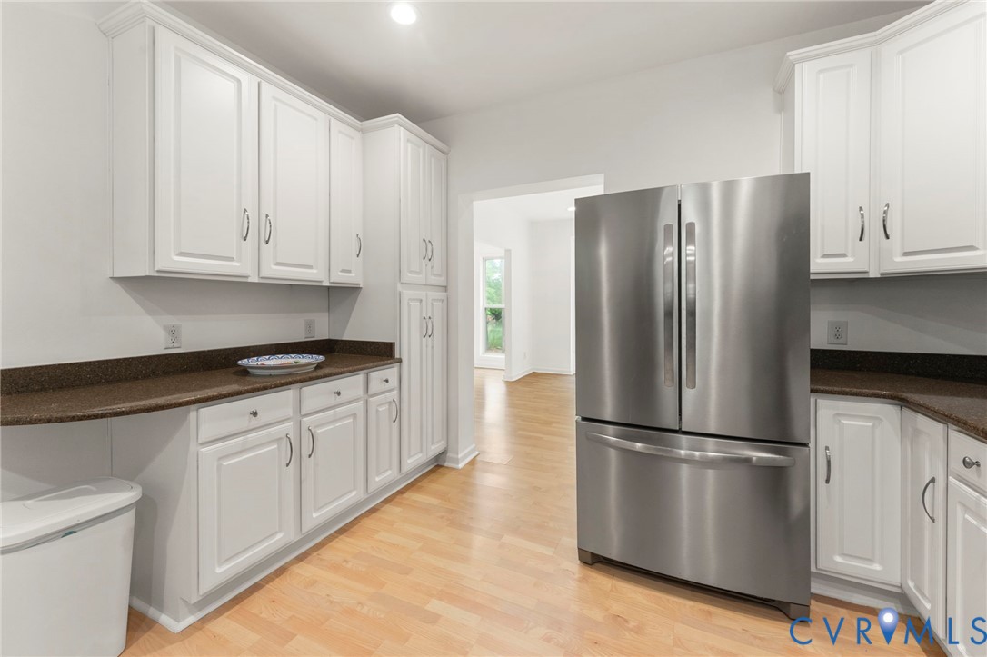 625 Whispering Pines Road Lancaster, VA 22503 - Photo 21 of 71 a kitchen with stainless steel appliances granite countertop a refrigerator sink and white cabinets