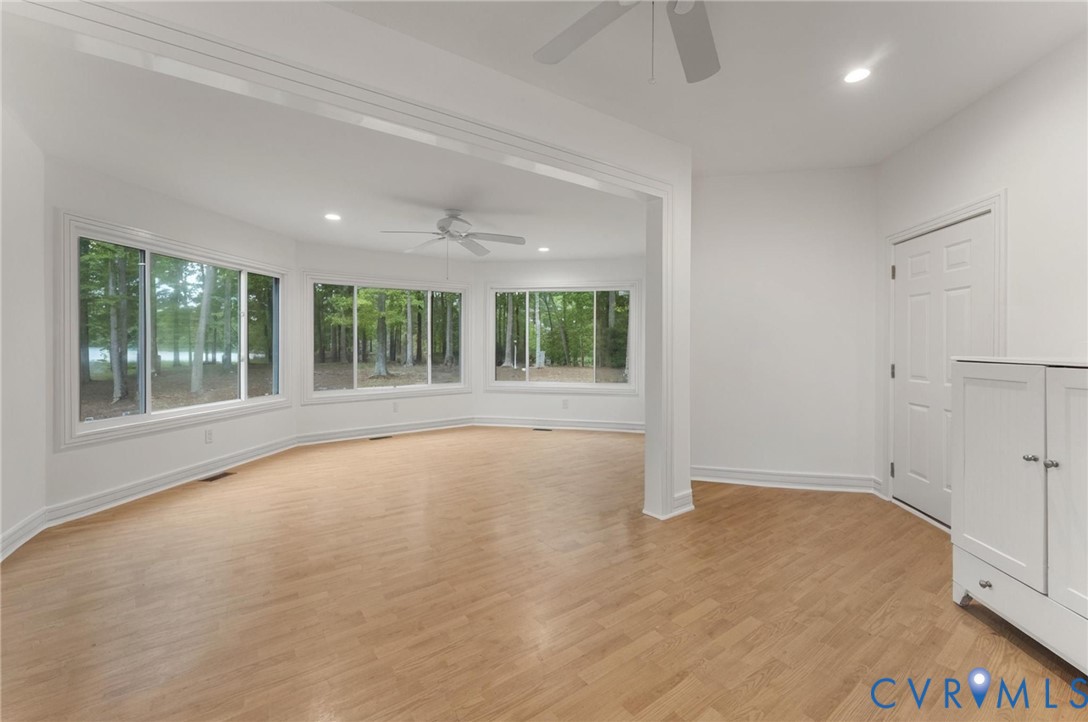 625 Whispering Pines Road Lancaster, VA 22503 - Photo 23 of 71 a view of an empty room with wooden floor and a window