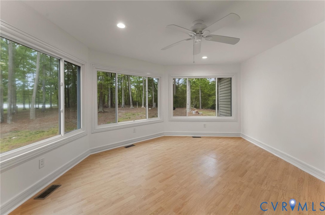 625 Whispering Pines Road Lancaster, VA 22503 - Photo 26 of 71 a view of an empty room with a window and a ceiling fan