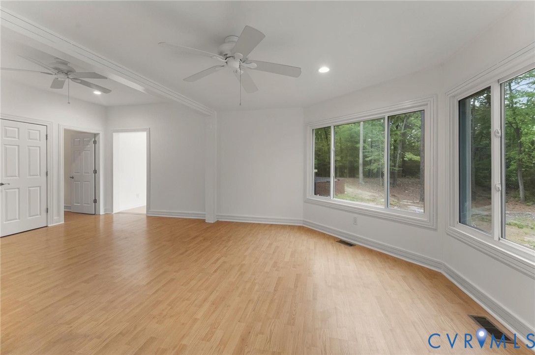 625 Whispering Pines Road Lancaster, VA 22503 - Photo 27 of 71 a view of an empty room with a window and wooden floor