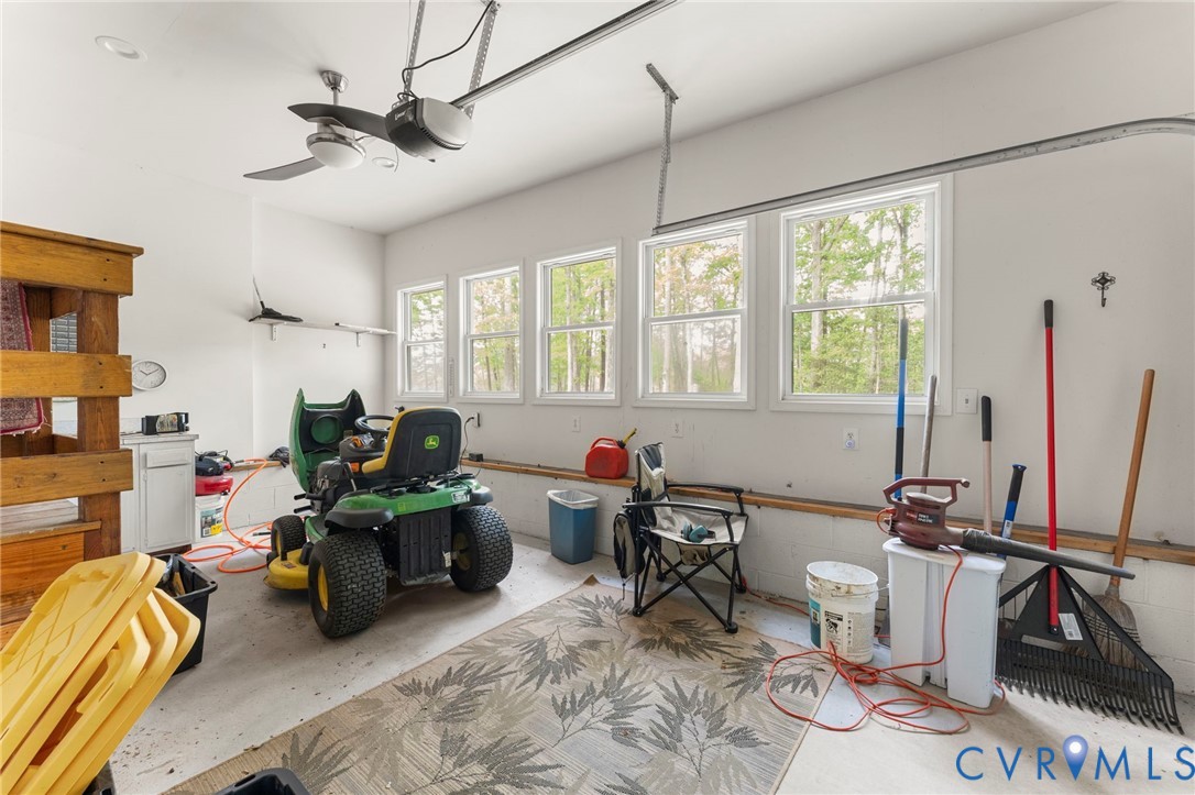 625 Whispering Pines Road Lancaster, VA 22503 - Photo 31 of 71 a living room with furniture a flat screen tv and a large window