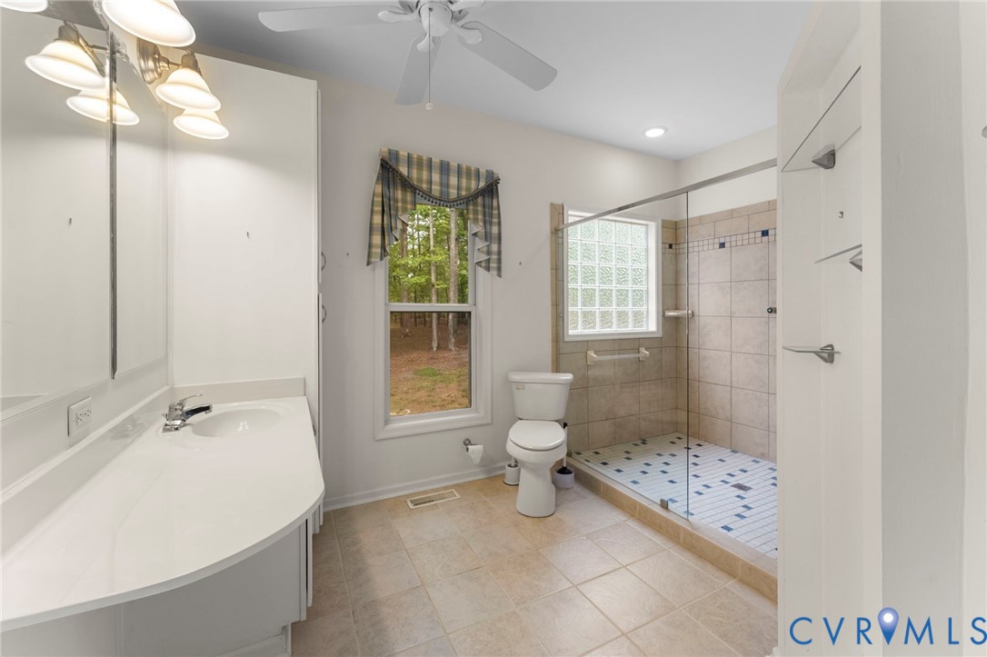 625 Whispering Pines Road Lancaster, VA 22503 - Photo 36 of 71 a spacious bathroom with a bathtub shower sink and toilet