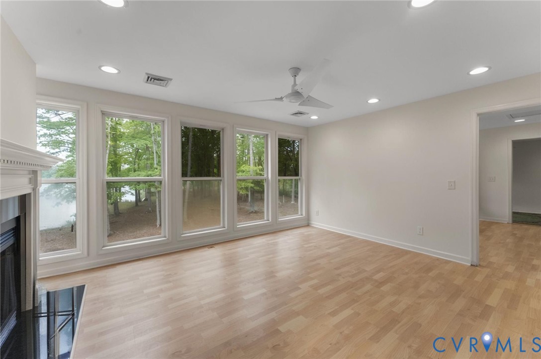 625 Whispering Pines Road Lancaster, VA 22503 - Photo 40 of 71 a view of an empty room with a window and wooden floor