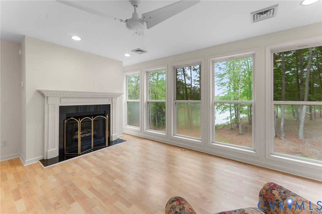 625 Whispering Pines Road Lancaster, VA 22503 - Photo 42 of 71 a view of an empty room with a fireplace and a window
