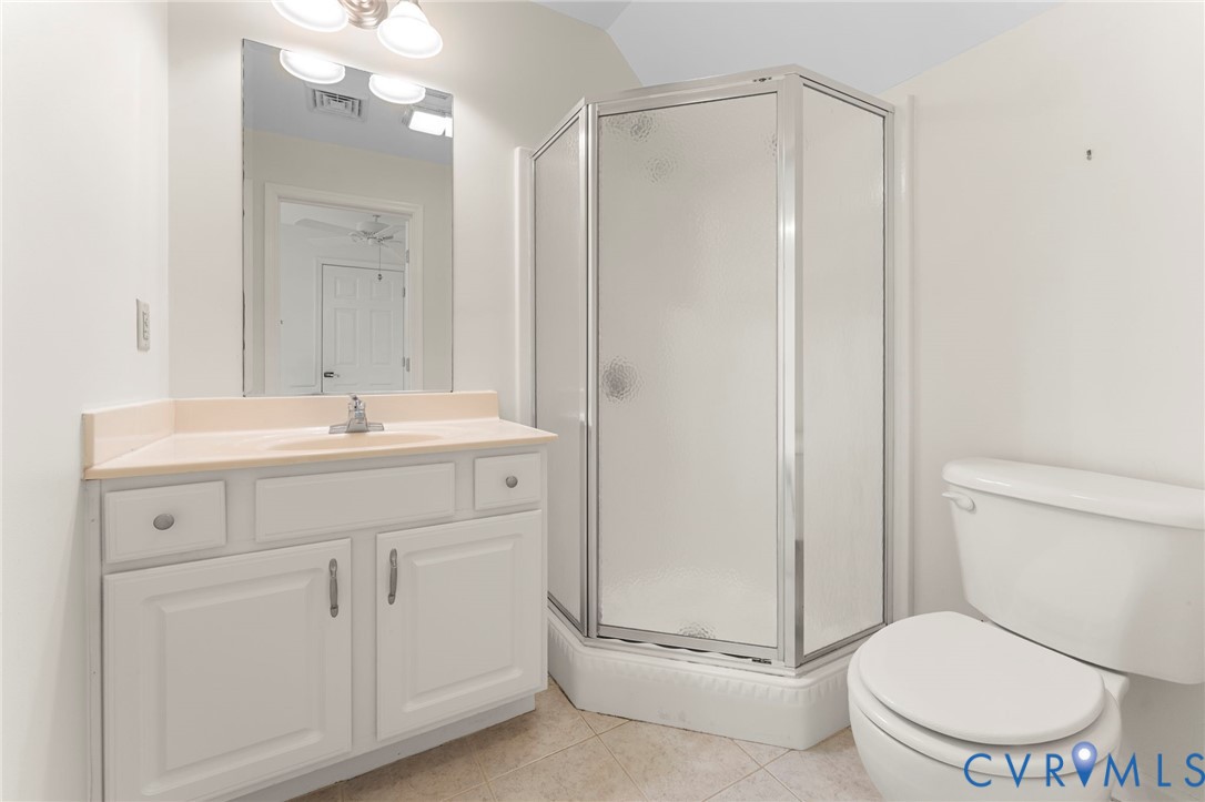 625 Whispering Pines Road Lancaster, VA 22503 - Photo 54 of 71 a bathroom with a toilet a sink a mirror and a shower