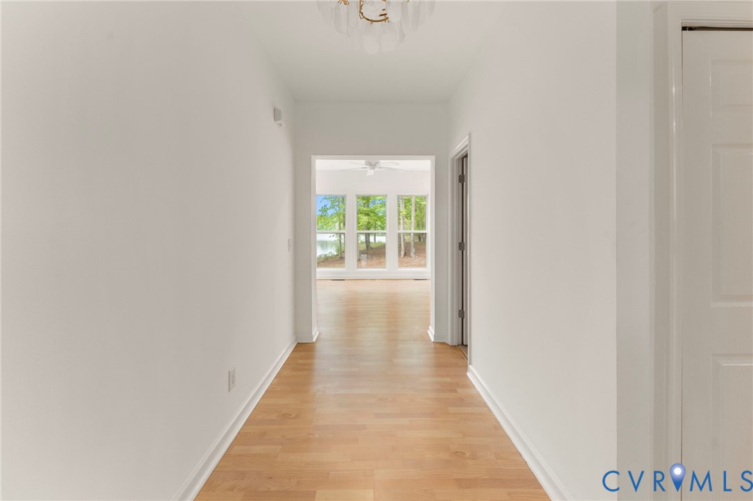 625 Whispering Pines Road Lancaster, VA 22503 - Photo 6 of 71 a view of a hallway with wooden floor