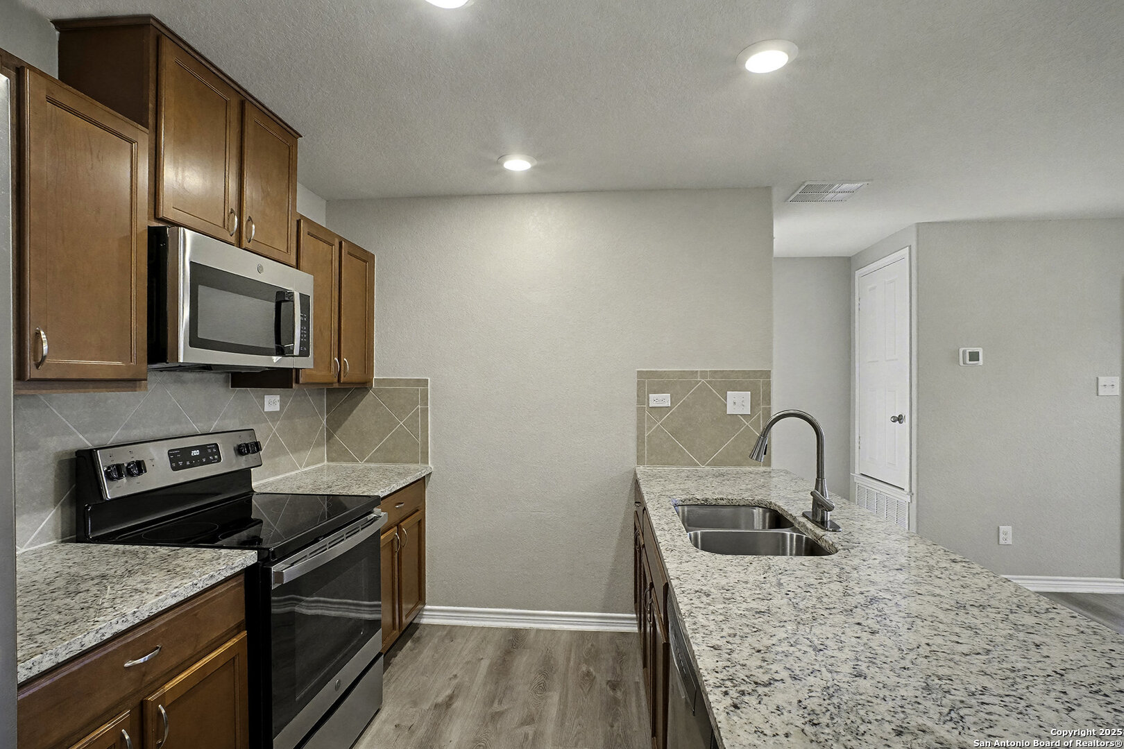 6508 Buffalo Ranch San Antonio, TX 78244 - Photo 13 of 31 a kitchen with a sink stove and refrigerator