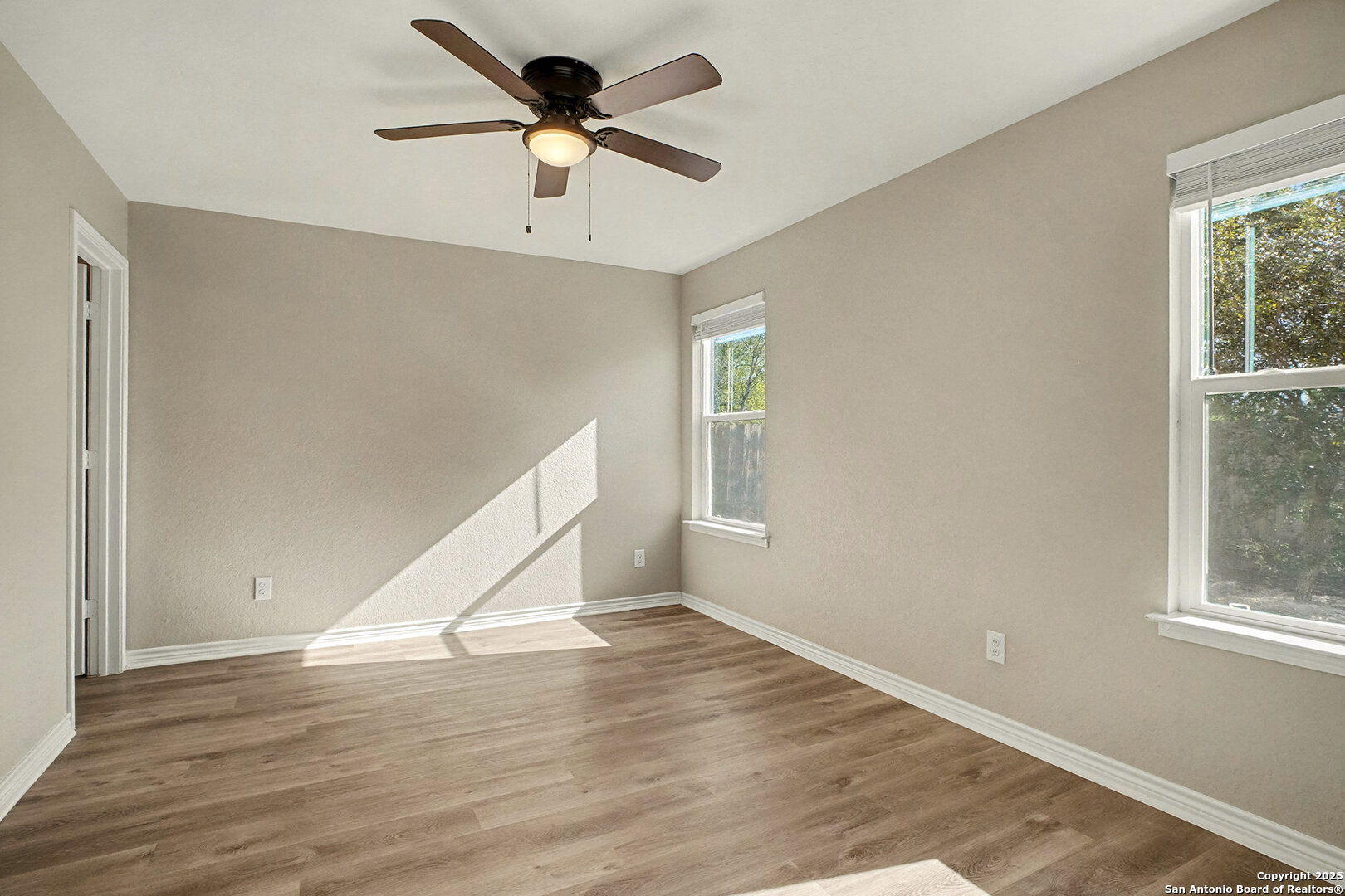 6508 Buffalo Ranch San Antonio, TX 78244 - Photo 16 of 31 a view of an empty room with wooden floor and a window