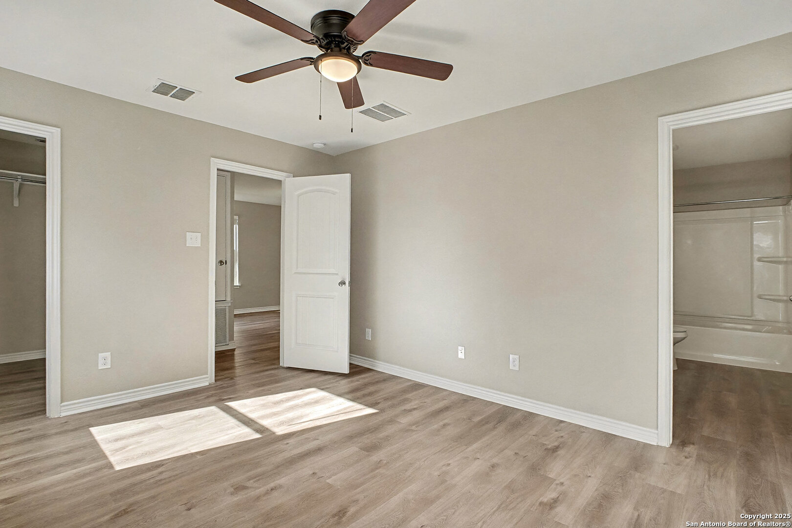 6508 Buffalo Ranch San Antonio, TX 78244 - Photo 18 of 31 an empty room with wooden floor and door