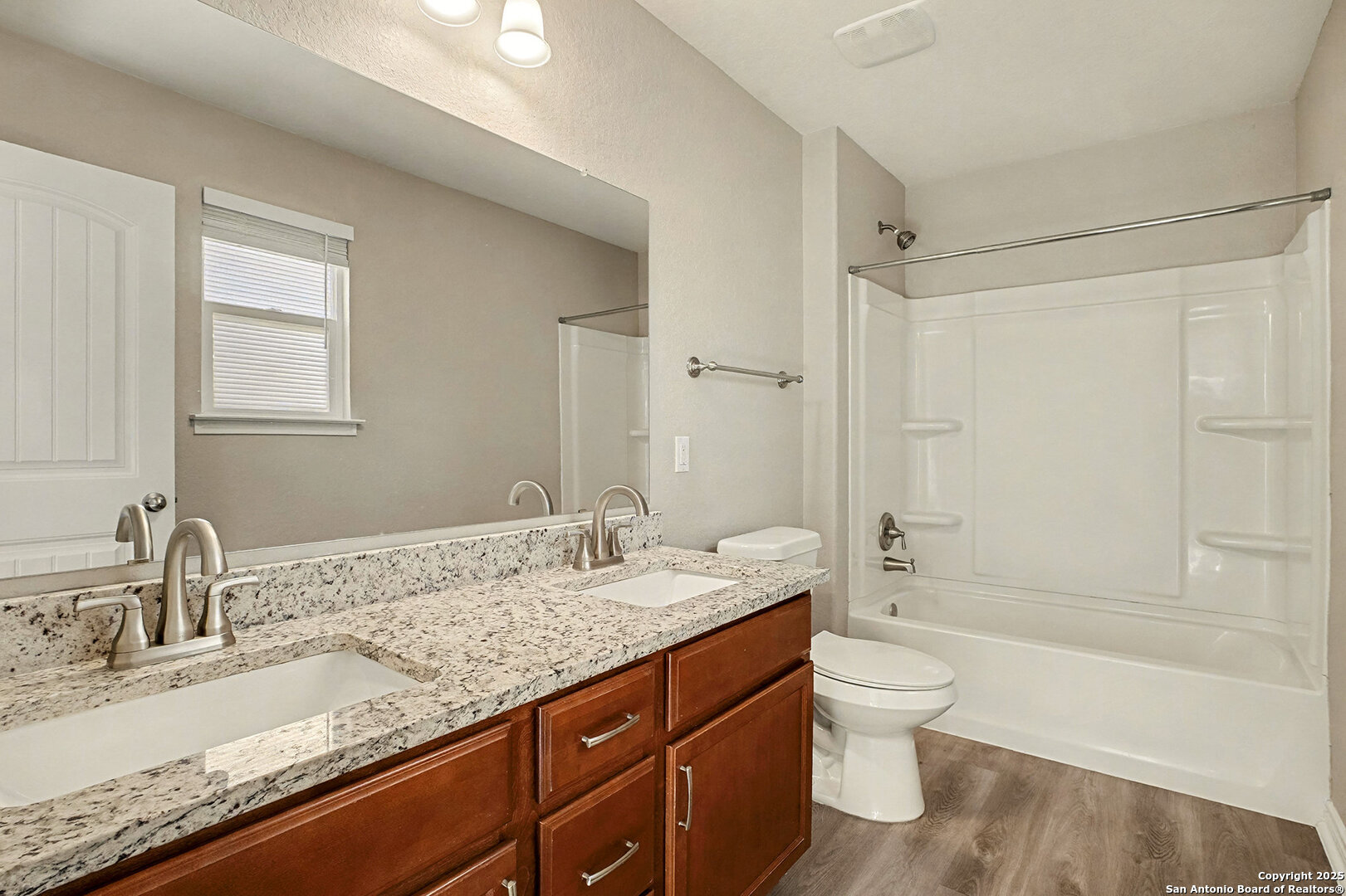 6508 Buffalo Ranch San Antonio, TX 78244 - Photo 19 of 31 a bathroom with a granite countertop sink a toilet and shower