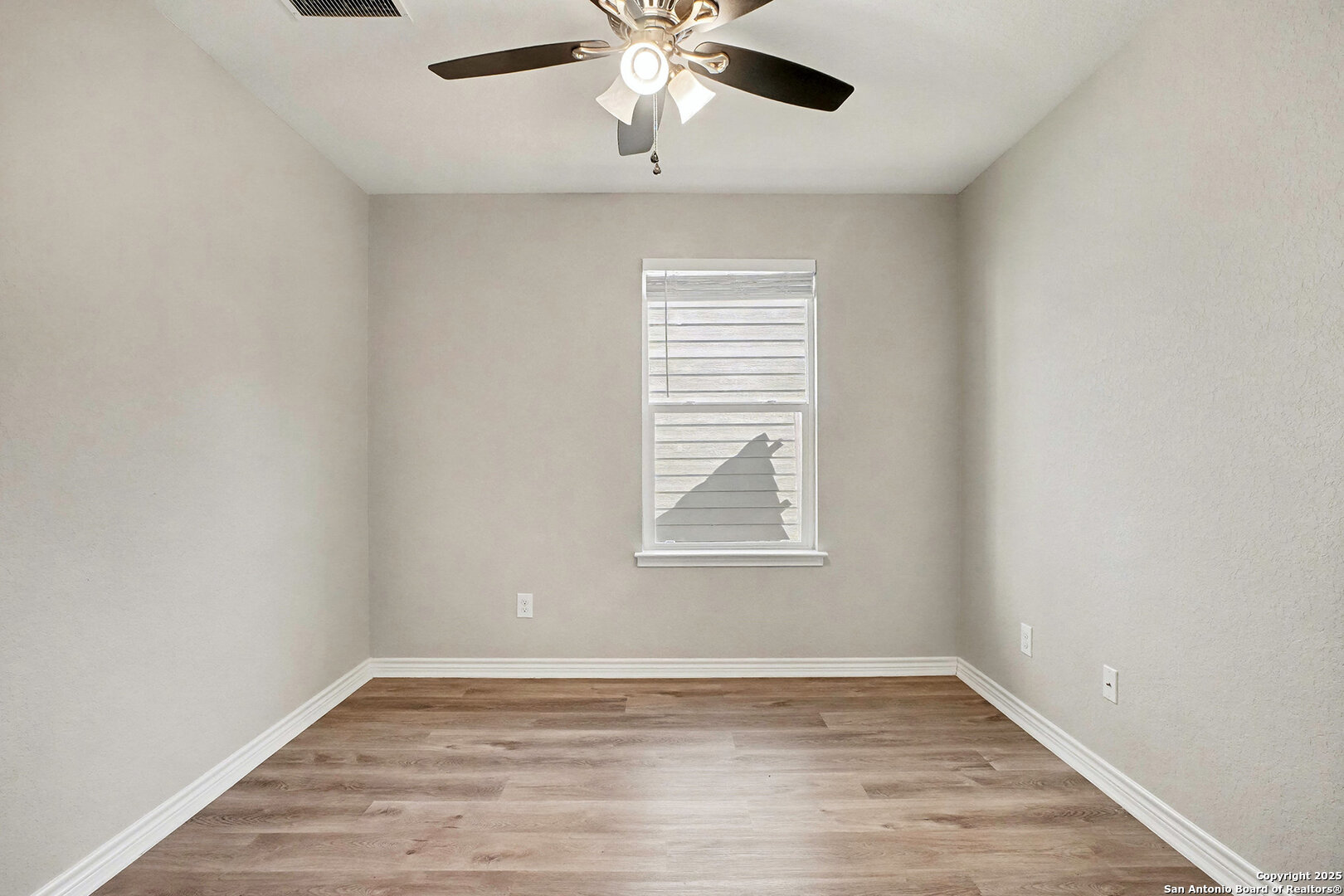 6508 Buffalo Ranch San Antonio, TX 78244 - Photo 20 of 31 an empty room with wooden floor fan and windows