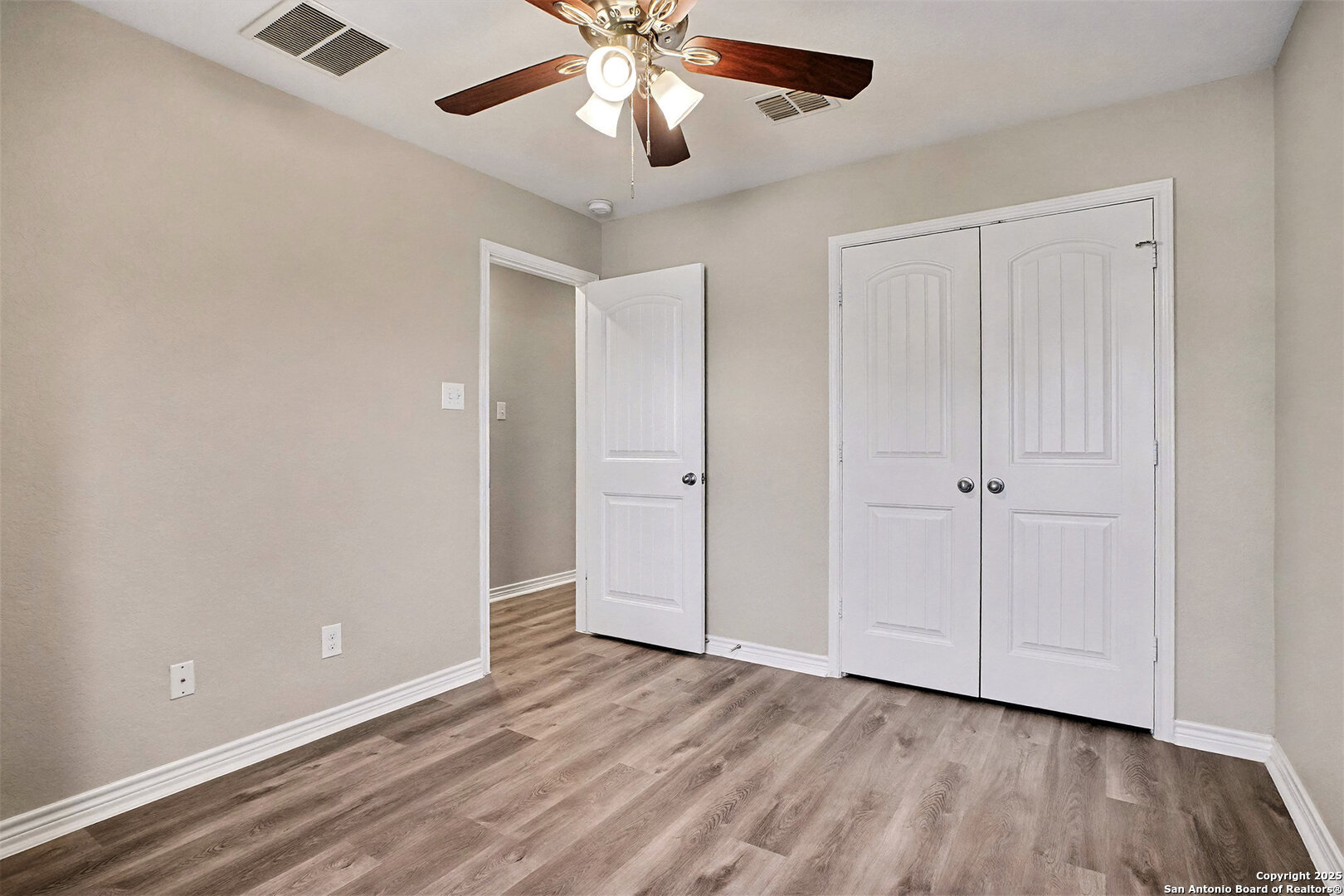 6508 Buffalo Ranch San Antonio, TX 78244 - Photo 23 of 31 an empty room with wooden floor closet and ceiling fan