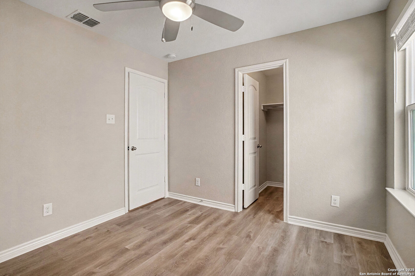 6508 Buffalo Ranch San Antonio, TX 78244 - Photo 25 of 31 an empty room with wooden floor and windows