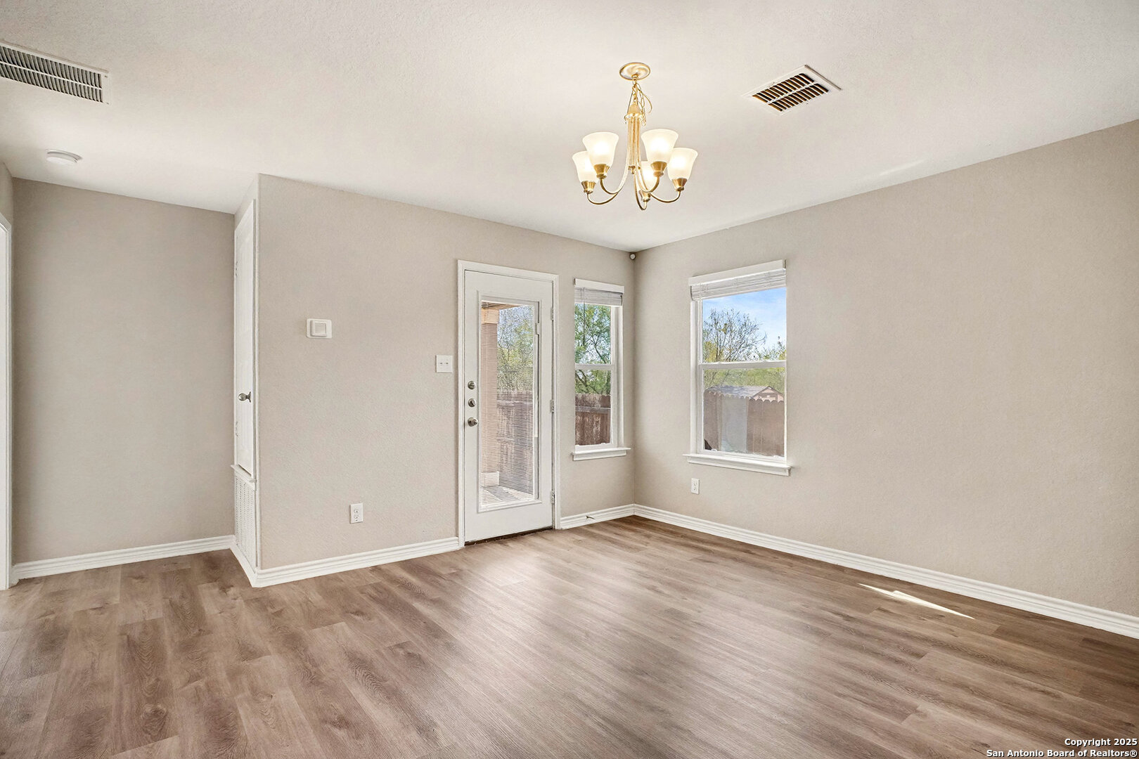 6508 Buffalo Ranch San Antonio, TX 78244 - Photo 5 of 31 a view of an empty room with a window and wooden floor