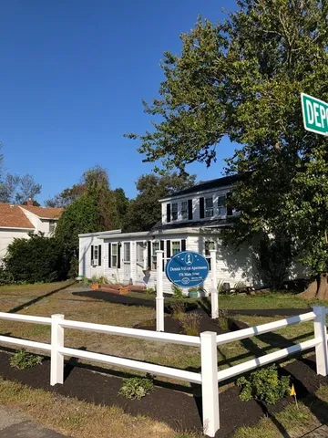 a view of house with swimming pool and outdoor seating