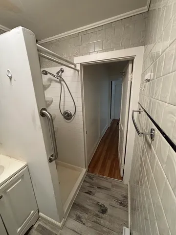 a view of closet with wooden floor