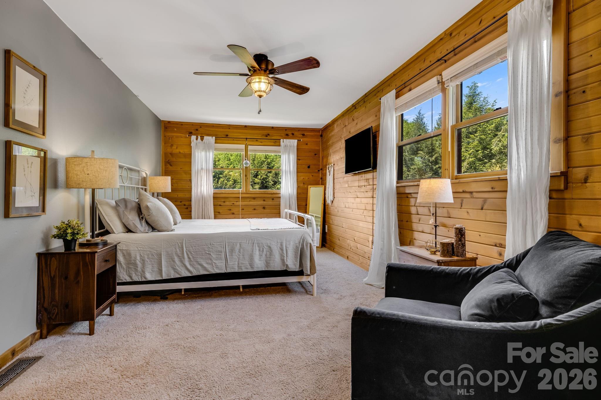 694 Boulder Road Marshall, NC 28753 - Photo 23 of 44 a bedroom with a bed and wooden floor