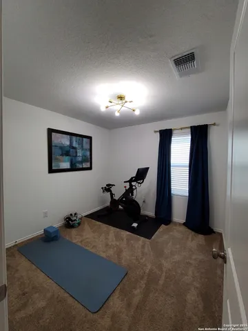 a bed room with a bed mirror and a window