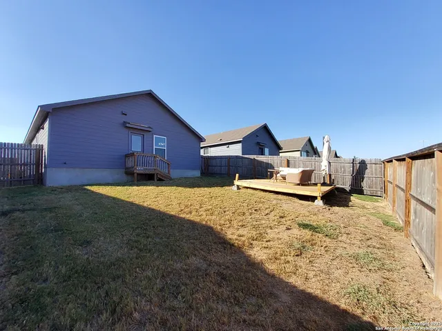 a house view with a backyard space