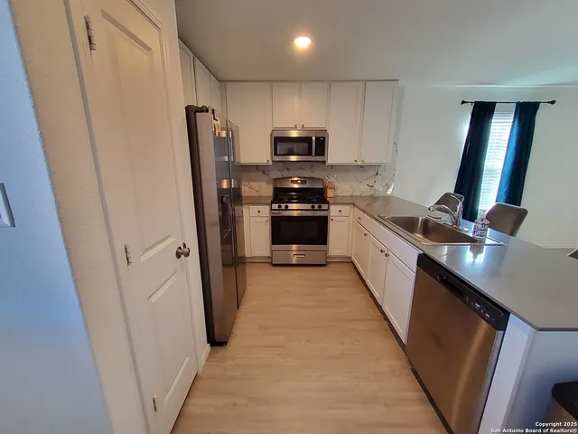 a kitchen with stainless steel appliances a refrigerator and a sink