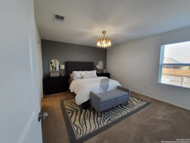 a bedroom with a bed and a lamp