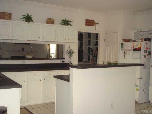 3620 Dewing Drive Raleigh, NC 27616 - Photo 8 of 12 Cooks kitchen! 5' center island with cooktop and plenty of counter space. Open pass through to family rm area.