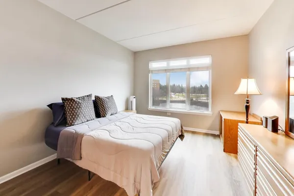 a bed room with a bed and a large window