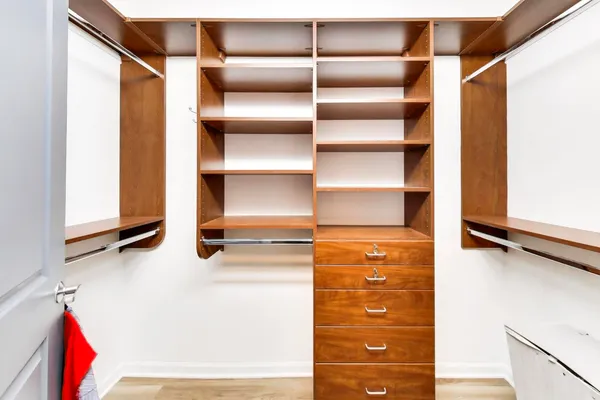 a view of walk in closet with empty racks
