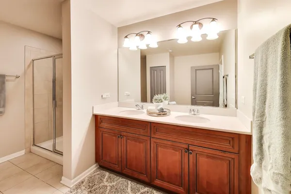 a bathroom with a double vanity sink and a mirror