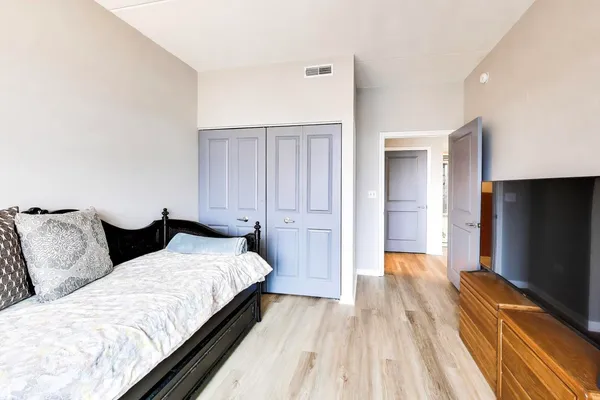 a bedroom with two beds and a flat screen tv