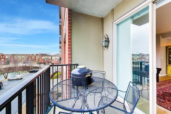 a view of a balcony with chair and a table