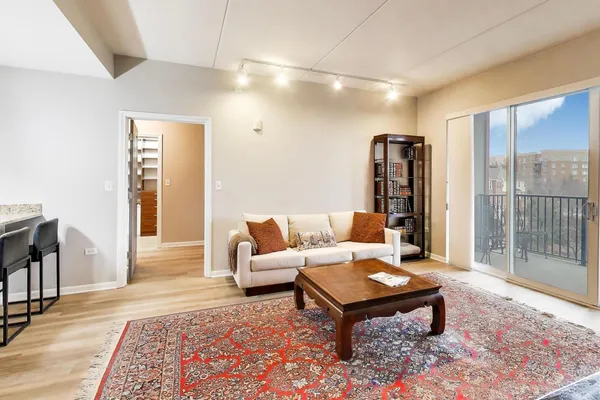 a living room with furniture lamp and rug